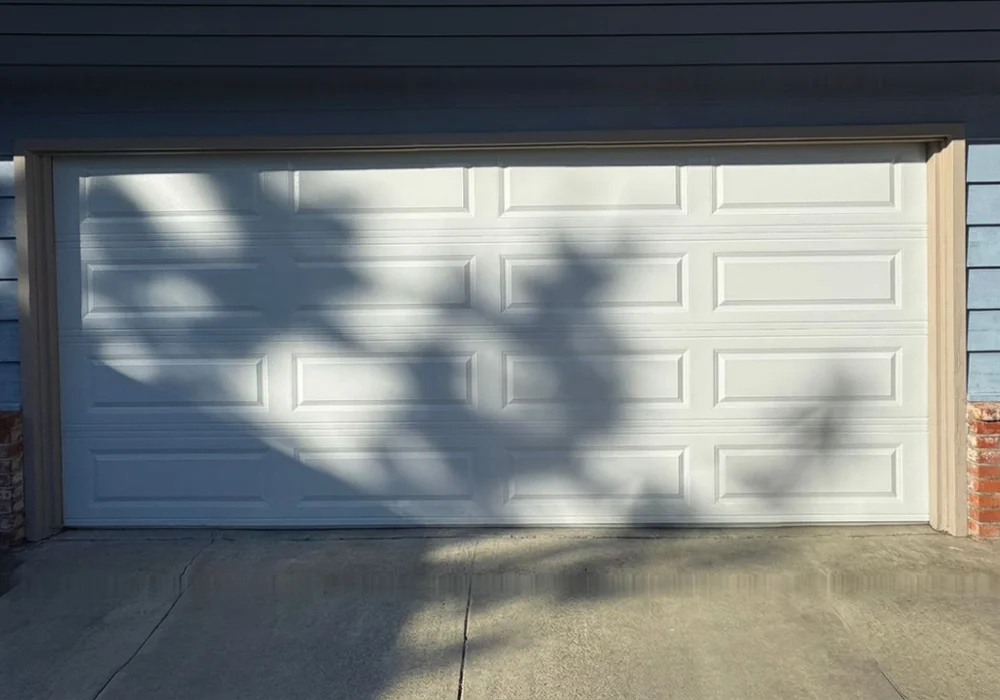 The same doors repaired and closed, seen from the driveway