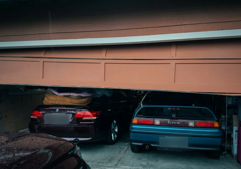 Terracotta garage door hanging off its track